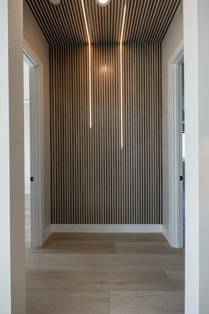 linear paneling at hall by Prodigy Homes