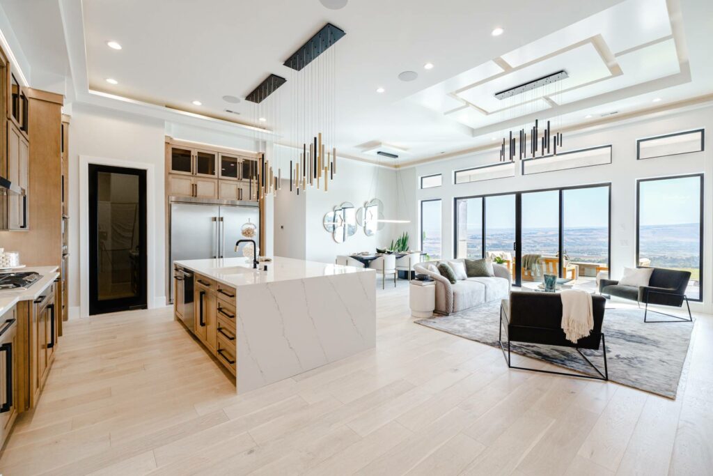 a luxury kitchen with the living area built by custom home builders in Pasco Prodigy Homes